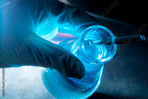 Blue science experiment glass tube,Researchers with chemistry test tubes in a liquid glass lab for analytical, medical, pharmaceutical and scientific research concepts