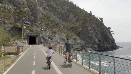 Italy , Liguria , June 2022 - Going bike from  Levanto Bonassola Framura cycle  pedestrian path - old galleries tunnels  in the rock by the sea - tourist attraction in the Cinque Terre photo