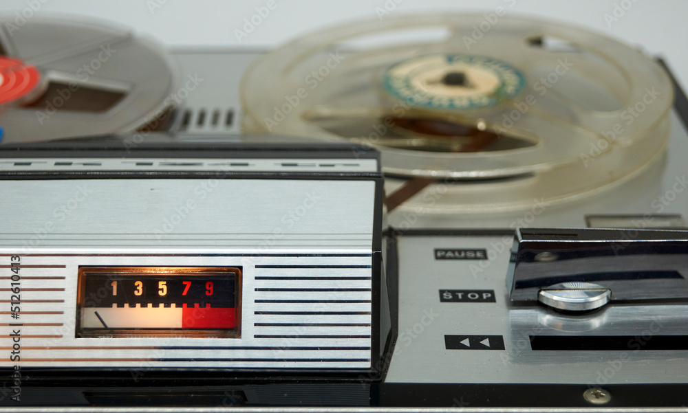 Fototapeta premium A vintage reel-to-reel tape recorder with a vu meter and a large switch from the seventies