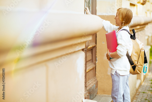 trendy school girl going to school outdoors in city