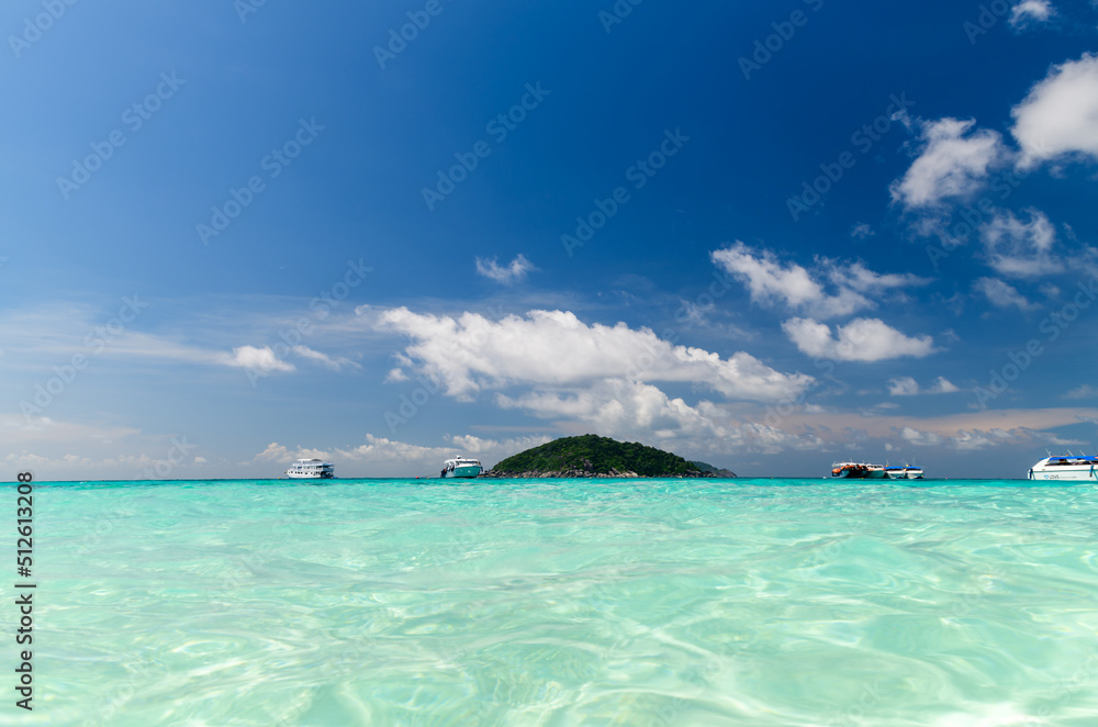 Speed boat on clear sea with white cloudy and blue sky at Similan Island, phang-nga Thailand