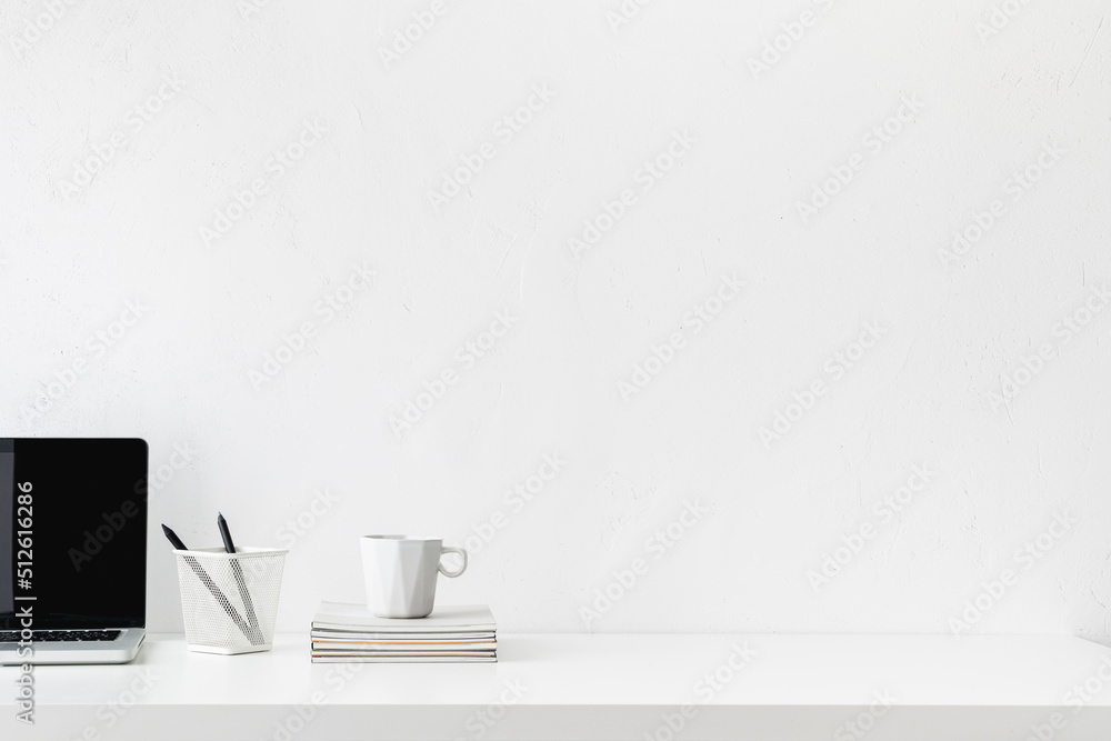 Simple workspace. Home office desk with laptop, papers and mug. Empty table product space. Simple workspace. Home office desk with laptop, papers and mug. Empty table product space.