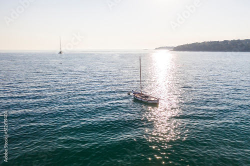 Aerial of Sailing boat in the adriatic sea by Rovinj city before sunset in summer