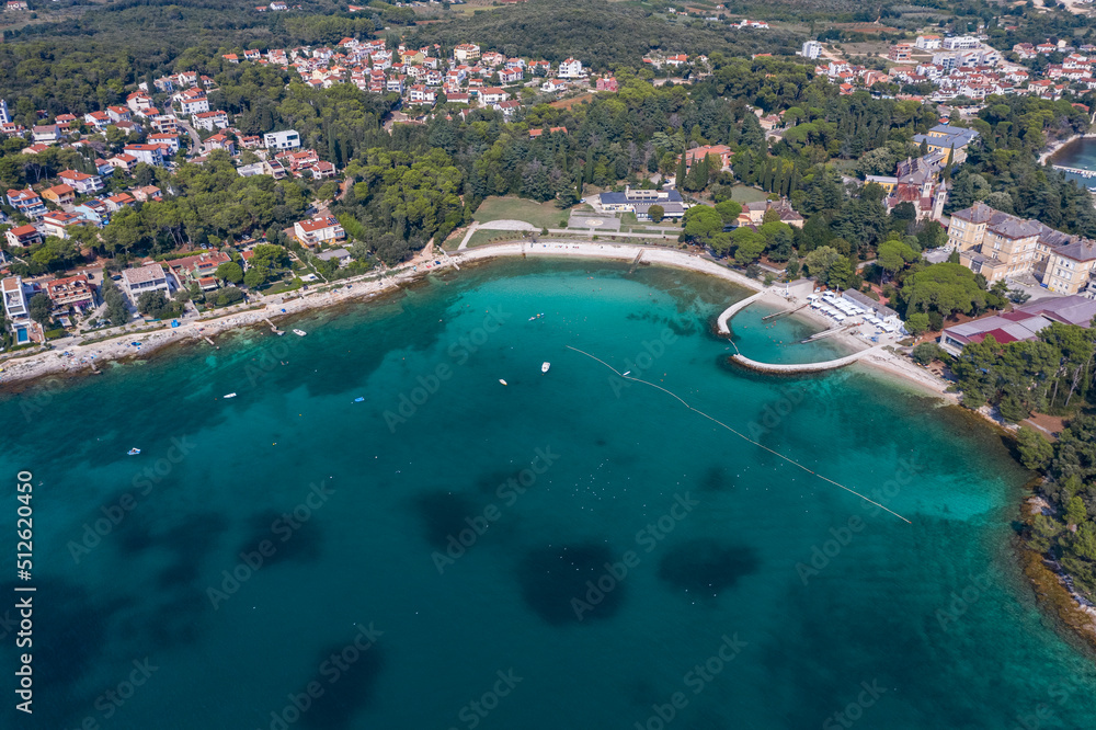 Aerial view of beach and resorts on the coast of Rovinj with green blue clear water on the Adriatic sea
