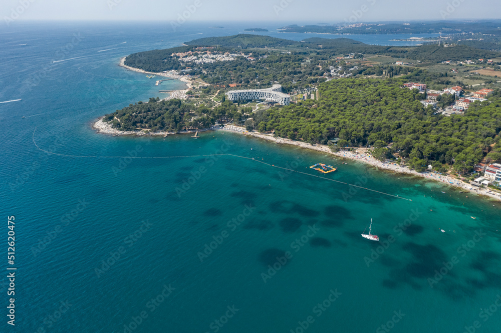 Aerial view of beach and resorts on the coast of Rovinj with green blue clear water on the Adriatic sea