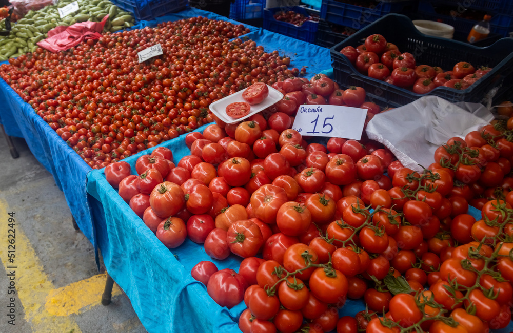 Buying fresh organic produce at the farmers' market. Fresh tomatoes on the counter Buying fresh organic produce at the farmers' market. Fresh tomatoes on the counter