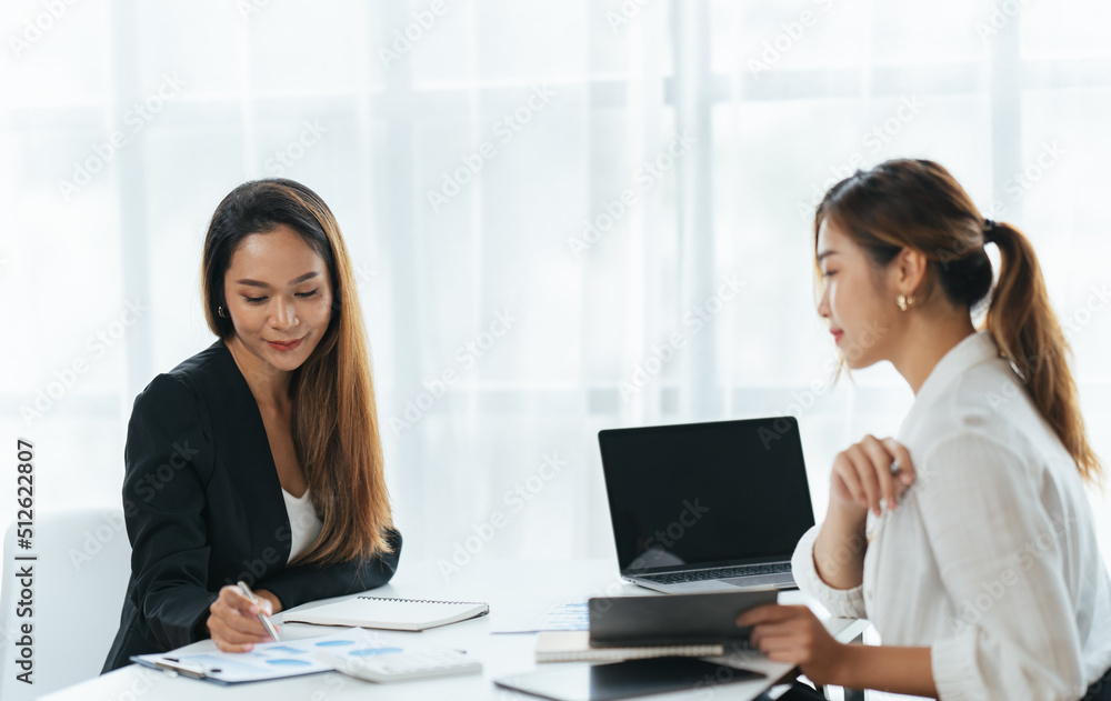 Happy young business colleagues in modern office,Two confident business ladies. Happy young business colleagues in modern office,Two confident business ladies.