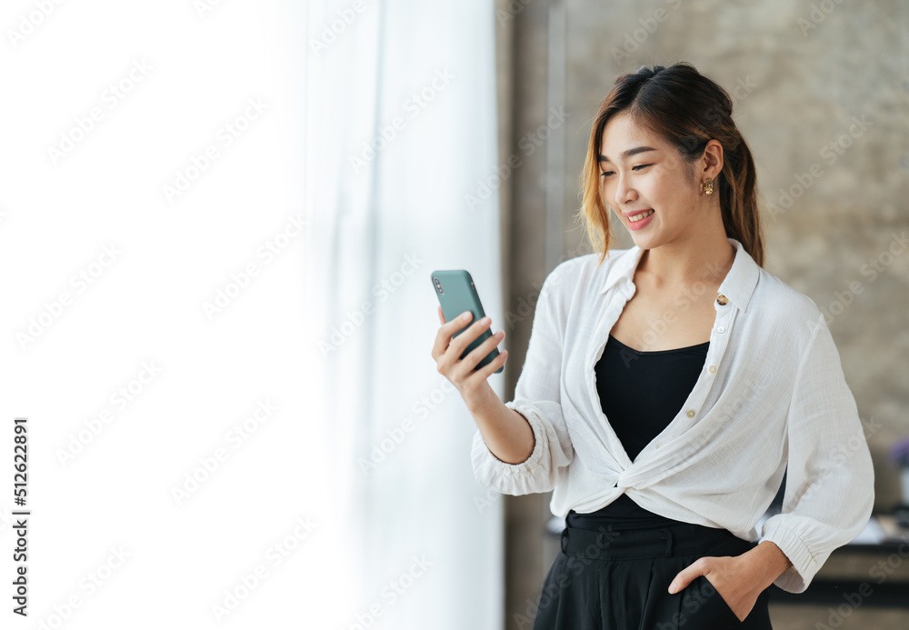 Portrait of a beautiful smiling woman using a mobile phone in office,Businesswoman taking a break and using smartphone. copy space. Portrait of a beautiful smiling woman using a mobile phone in office,Businesswoman taking a break and using smartphone. copy space.