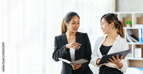 Group Of Businesswomen Collaborating In Creative Meeting Around Table In Modern Office, Female executive putting her ideas during presentation in conference room.