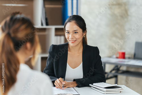 Group Of Businesswomen Collaborating In Creative Meeting Around Table In Modern Office, Female executive putting her ideas during presentation in conference room.