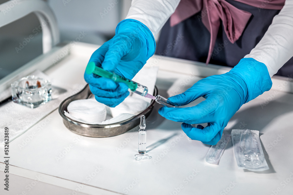 doctor takes the medicine from the ampoule into the syringe doctor takes the medicine from the ampoule into the syringe