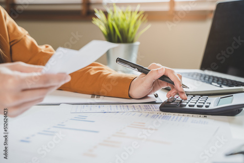 Konstfotografi person using calculator calculating tax refund on the table