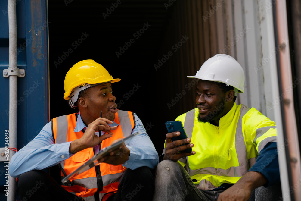 African American working engineer foreman talk while taking a break African American working engineer foreman talk while taking a break