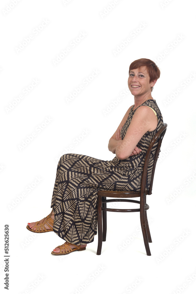 side view of a middle aged woman sitting on a chair with arms crossed on white background side view of a middle aged woman sitting on a chair with arms crossed on white background