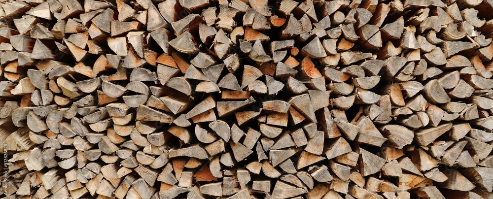 stacked dry firewood as a background 