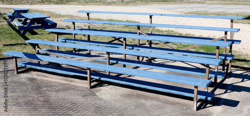 Small town USA blue wood baseball bleachers. photo