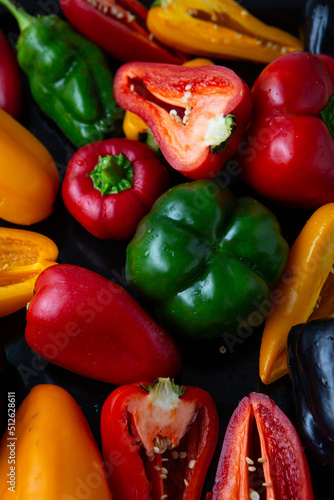 Yellow green red black bell pepper top view food background