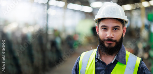 Portrait Professional mechanical engineering hispanic male in white safety hard hat helmet and look at camera at metal factory. © NVB Stocker