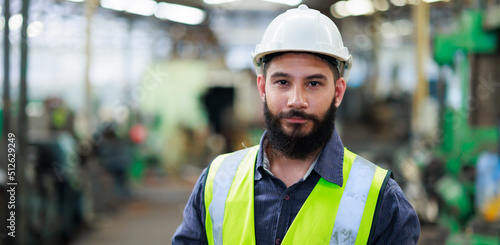 Portrait Professional mechanical engineering hispanic male in white safety hard hat helmet and look at camera at metal factory. photo