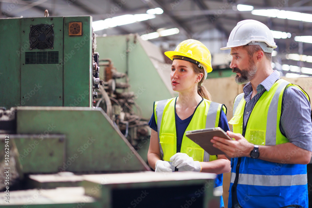 Training trainee concept. Hispanic latin male engineer explain the procedure for using the correct metal robot machine at lathe industrial factory. Training trainee concept. Hispanic latin male engineer explain the procedure for using the correct metal robot machine at lathe industrial factory.