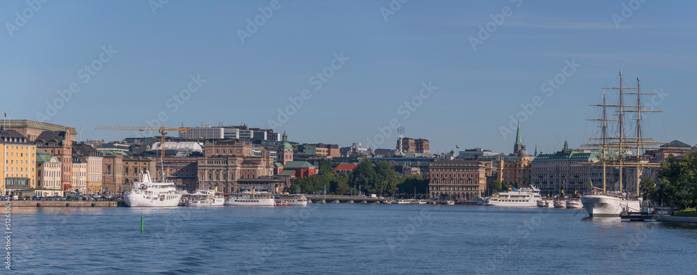 The bay Saltsjön, piers, the old town Gamla Stan, the garden Kungsträdgården, office houses, steam ships and museums a summer day in Stockholm