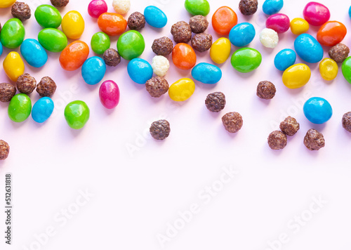Colorful chocolate and jellybeans candy background top view