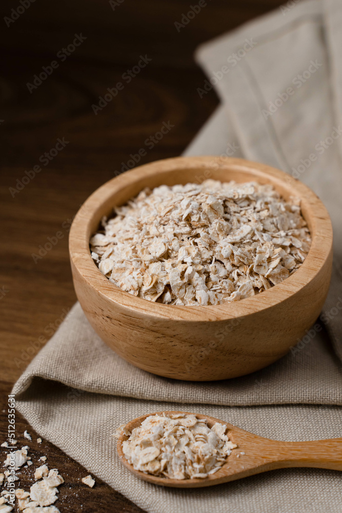 Rolled oats, healthy breakfast, cereals, oatmeal in a bowl on a wooden table. Rolled oats, healthy breakfast, cereals, oatmeal in a bowl on a wooden table.
