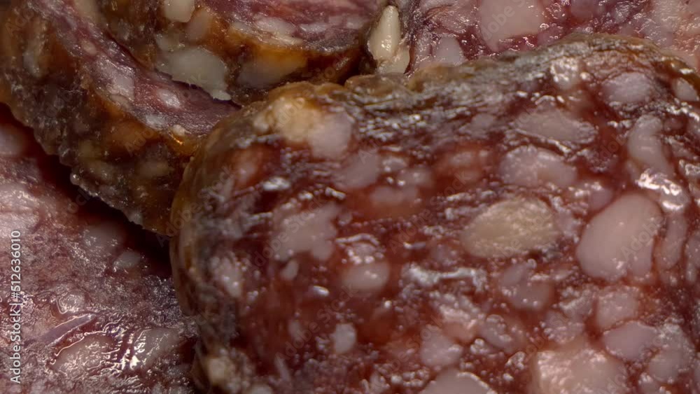 Pieces of smoked salami, macro video. Sausage. Sliding shot, full frame. Pieces of smoked salami, macro video. Sausage. Sliding shot, full frame.