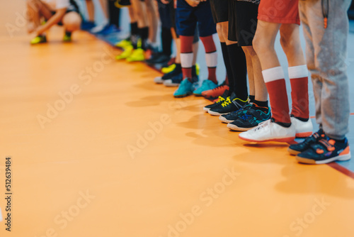 Sporty school kids standing in a line at physical education class. Legs of kids on sports indoor class © matimix