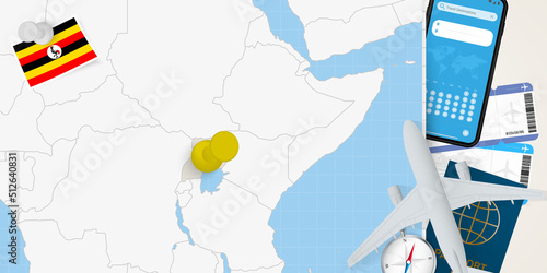 Travel to Uganda concept, map with pin on map of Uganda. Vacation preparation map, flag, passport and tickets.