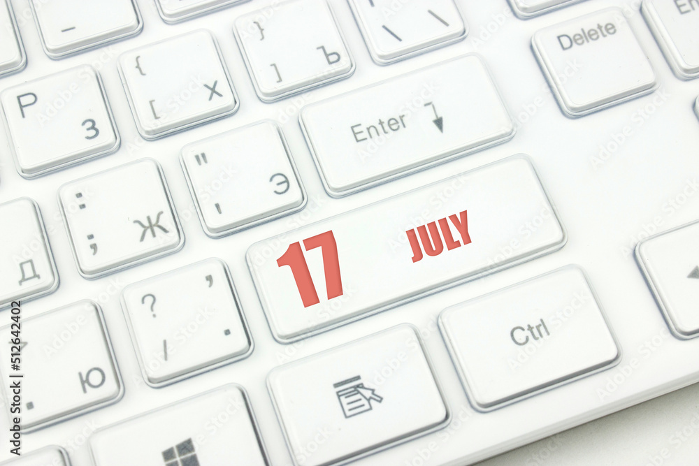 July 17th. Day 17 of month, Calendar date. Cropped view of Modern White Computer Keyboard with calendar date. Concept workspace, freelance, deadline. Summer month, day of the year concept. July 17th. Day 17 of month, Calendar date. Cropped view of Modern White Computer Keyboard with calendar date. Concept workspace, freelance, deadline. Summer month, day of the year concept.