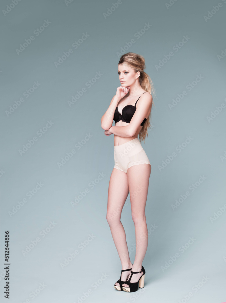 Modelling the latest in lingerie. A gorgeous young blond modelling in a studio shoot.