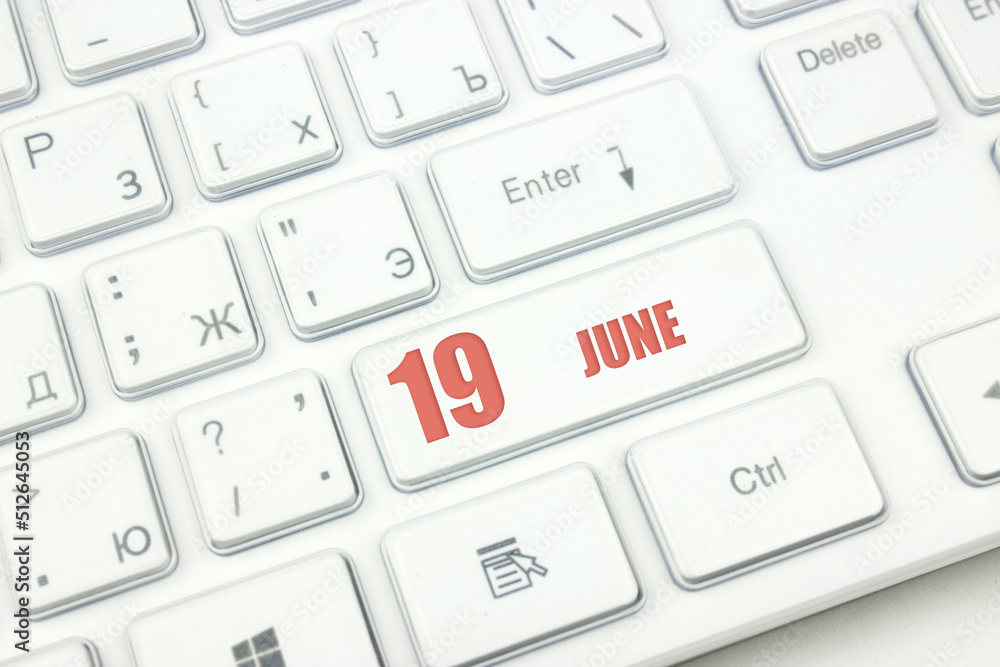 June 19th. Day 19 of month, Calendar date. Cropped view of Modern White Computer Keyboard with calendar date. Concept workspace, freelance, deadline. Summer month, day of the year concept. June 19th. Day 19 of month, Calendar date. Cropped view of Modern White Computer Keyboard with calendar date. Concept workspace, freelance, deadline. Summer month, day of the year concept.