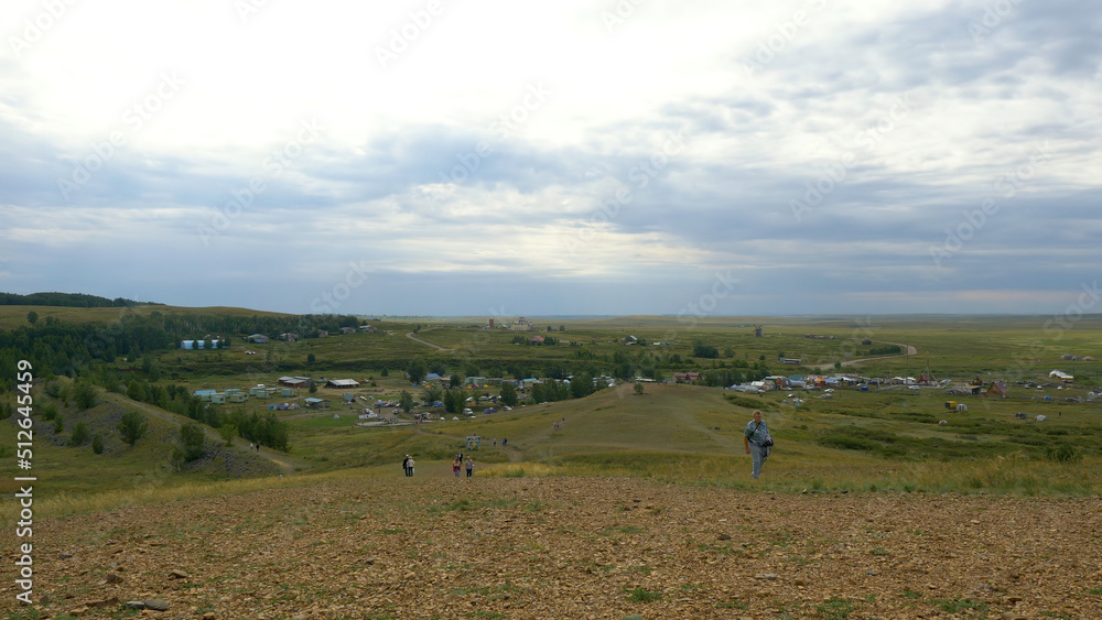 The village is in the mountains and grass in a mountainous area, a small settlement in the highlands