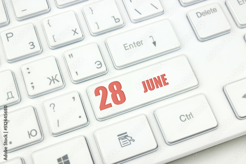 June 28th. Day 28 of month, Calendar date. Cropped view of Modern White Computer Keyboard with calendar date. Concept workspace, freelance, deadline. Summer month, day of the year concept. June 28th. Day 28 of month, Calendar date. Cropped view of Modern White Computer Keyboard with calendar date. Concept workspace, freelance, deadline. Summer month, day of the year concept.