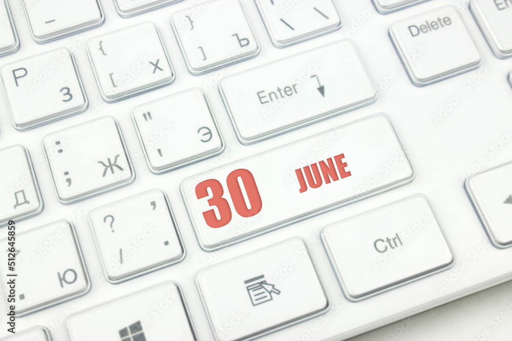 June 30th. Day 30 of month, Calendar date. Cropped view of Modern White Computer Keyboard with calendar date. Concept workspace, freelance, deadline. Summer month, day of the year concept. June 30th. Day 30 of month, Calendar date. Cropped view of Modern White Computer Keyboard with calendar date. Concept workspace, freelance, deadline. Summer month, day of the year concept.