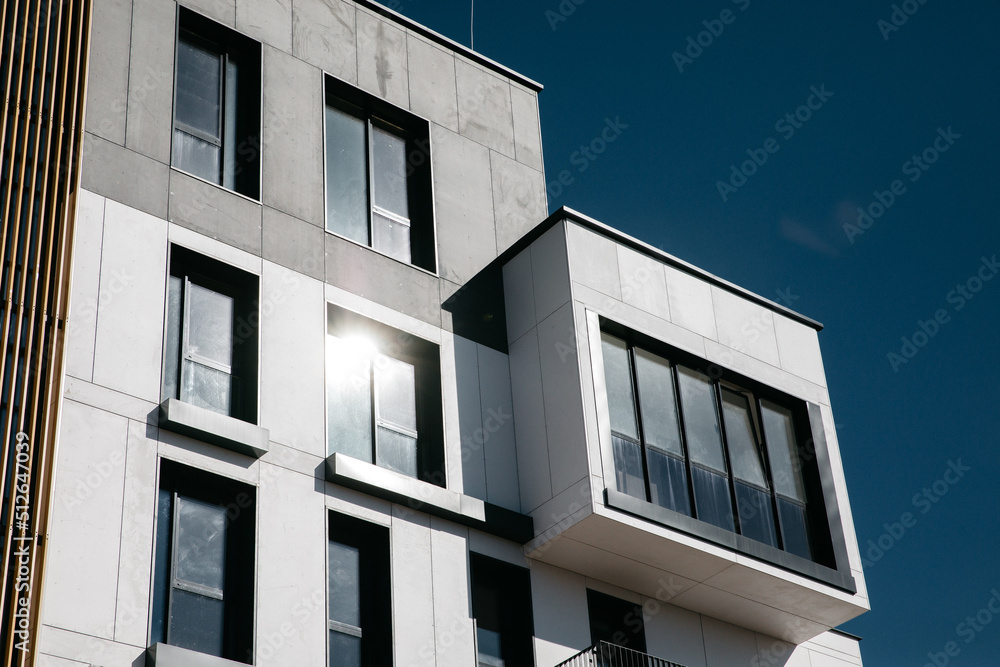 Modern apartment buildings Facade with a blue sky. Glass surface with sunlight. Modern apartment buildings Facade with a blue sky. Glass surface with sunlight.