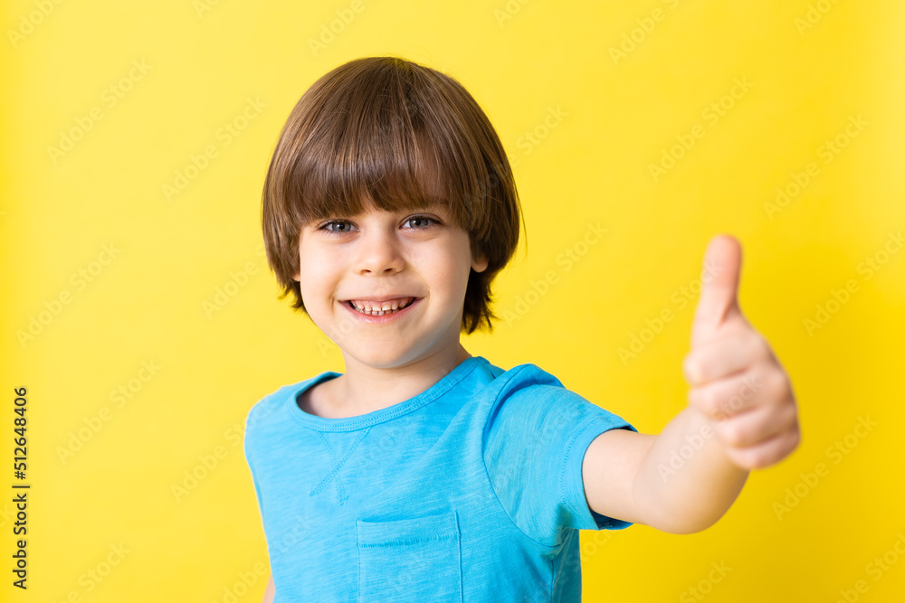 handsome little boy in blue shirt, yellow background, banner, space for text handsome little boy in blue shirt, yellow background, banner, space for text
