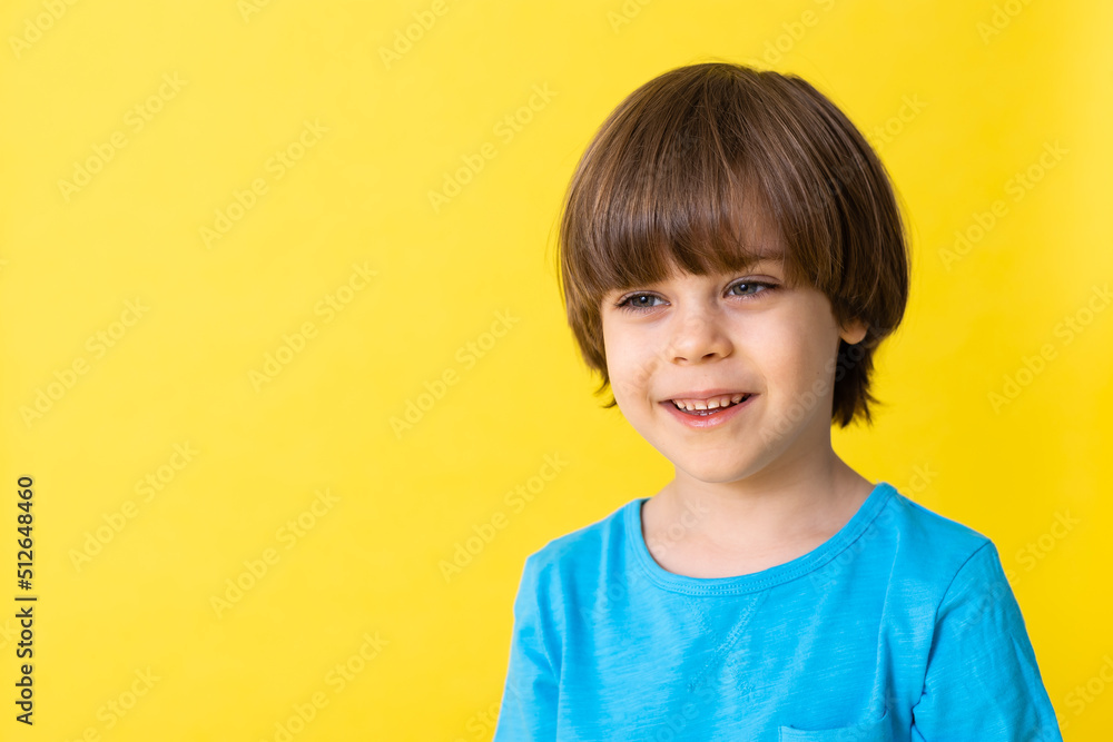 handsome little boy in blue shirt, yellow background, banner, space for text handsome little boy in blue shirt, yellow background, banner, space for text