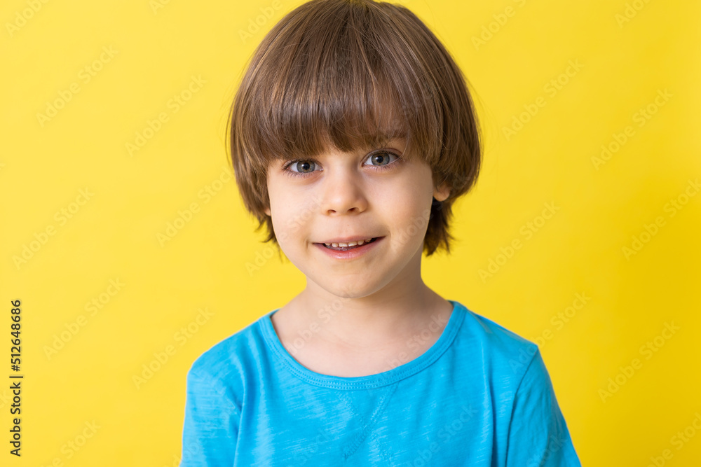 handsome little boy in blue shirt, yellow background, banner, space for text handsome little boy in blue shirt, yellow background, banner, space for text