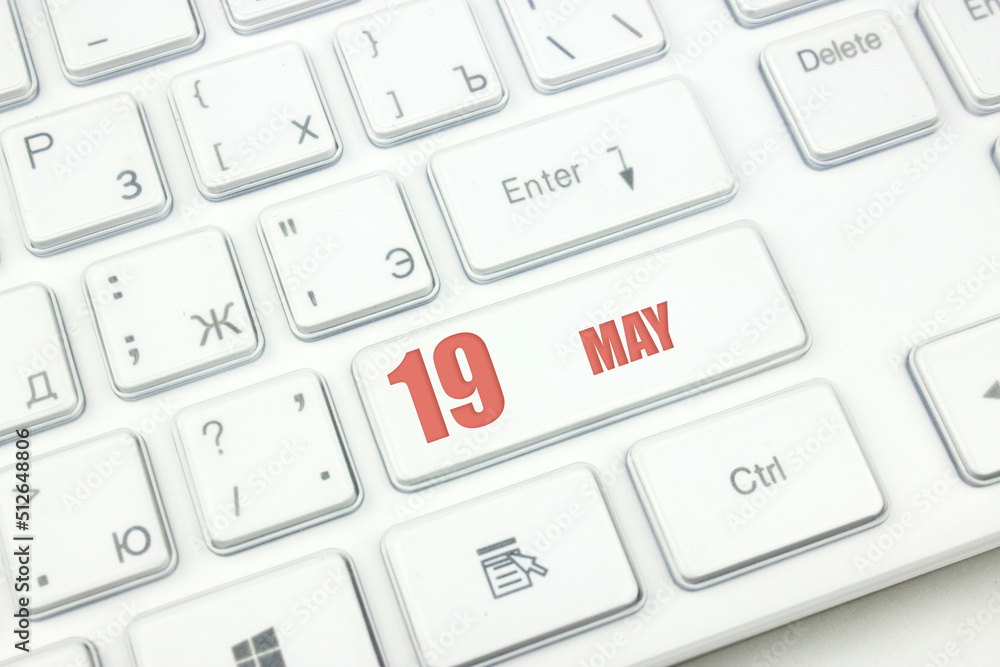 May 19th. Day 19 of month, Calendar date. Cropped view of Modern White Computer Keyboard with calendar date. Concept workspace, freelance, deadline. Spring month, day of the year concept. May 19th. Day 19 of month, Calendar date. Cropped view of Modern White Computer Keyboard with calendar date. Concept workspace, freelance, deadline. Spring month, day of the year concept.