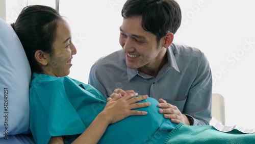 Husband happy feeling with pregnant belly of wife. Man touching belly of pregnant woman.