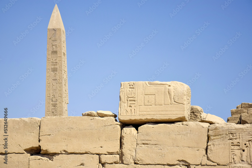 Tall pillar with carved ancient hieroglyphs in Karnak Temple complex. Legacy of past centuries, heritage. Luxor, Egypt. Copy space.
