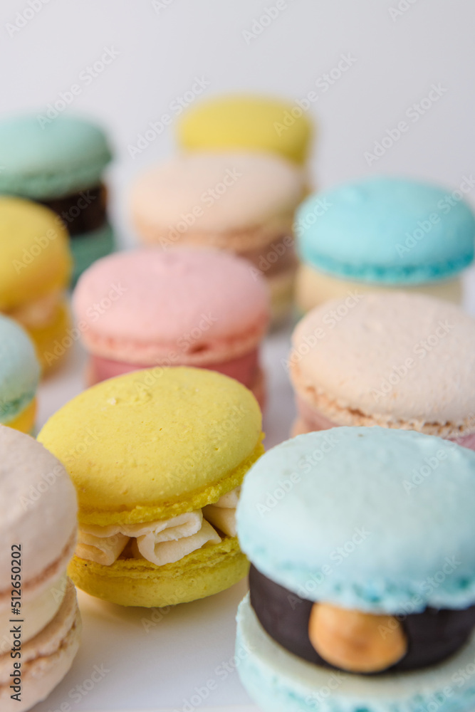 many colorful macaroons arranged on a white background chaotically