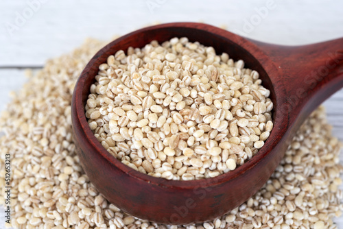 Close up of pearl barley in wooden scoop