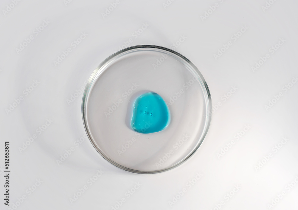 Laboratory glass petri dish with drop of water, serum, oil, beauty product. Natural medicine, cosmetic research, bio science. Concept of skincare and analysis. Dermatology. Flat lay, top view Laboratory glass petri dish with drop of water, serum, oil, beauty product. Natural medicine, cosmetic research, bio science. Concept of skincare and analysis. Dermatology. Flat lay, top view