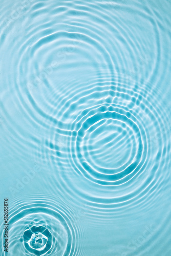 Blue water texture, surface with rings and ripples. Spa concept background. Flat lay, copy space.