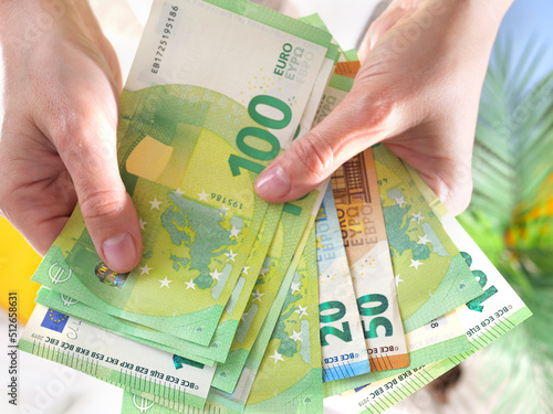 Fotografie Hands hold different euro banknotes