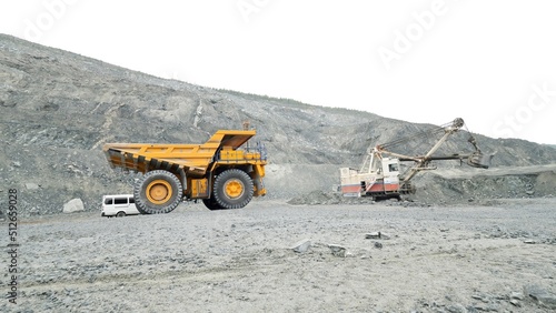 Heavy mining trucks moving on a limestone quarry. Heavy equipment.