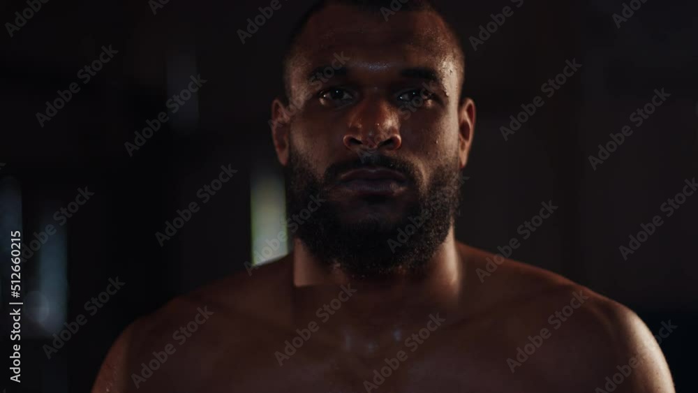 MMA fighter. Portrait of the man fighter standing in the dark gym MMA fighter. Portrait of the man fighter standing in the dark gym